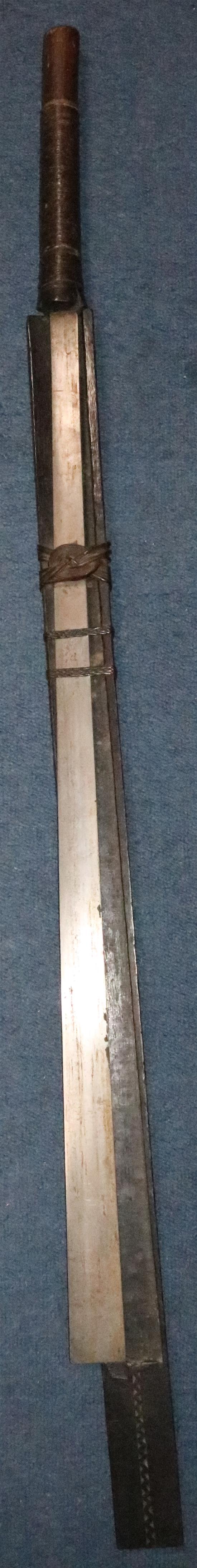 A Naga Dao sword and hardwood scabbard, Assam. 19th century, total length 114.5cm (45in.)